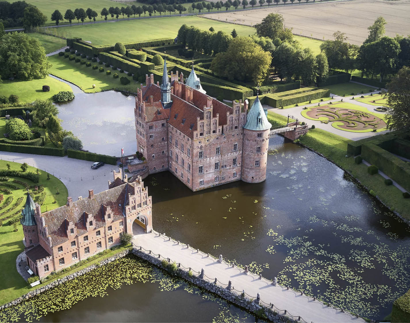 A large castle is reflected in the water. Description generated by AI